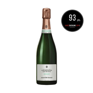 Bottle of champagne with a James Suckling score label on a white background