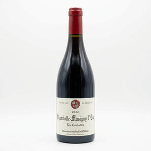 a dark glass bottle with a cream-colored label and a red foil capsule, set against a plain white background.