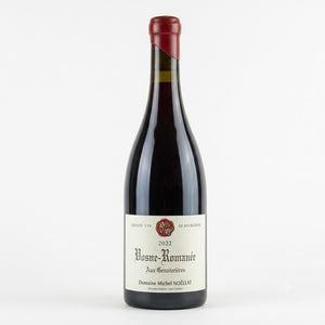 A bottle of Domaine Michel Noëlat Rosne-Komanée 2022 Grand Vin de Bourgogne red wine, featuring a dark glass bottle, cream-colored label, and a dark red foil seal on a white background.