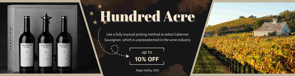Wine bottles with a promotional banner for Hundred Acre wine, featuring a vineyard background.