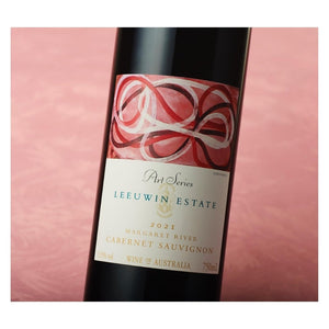Leeuwin Estate Art Series Cabernet Sauvignon 2021 wine bottle with label on a pink background