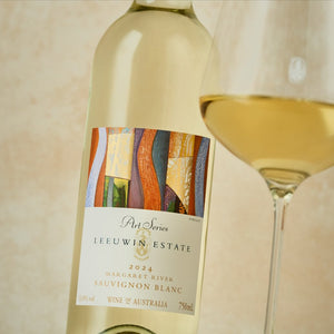 Leeuwin Estate Art Series Sauvignon Blanc 2024 bottle with a glass of wine on a beige background
