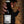 Bottle of R. Faivre champagne held by a hand with a blurred background
