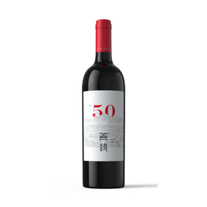 A bottle of Xige Estate N50 2020 wine with a red cap and a label primarily in white and red, indicating the wine variety and vintage.