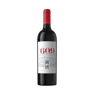 A bottle of 2020 Xige Estate N609 red wine with a white label, red text, and a red cap.